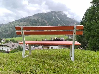 a bench sitting on top of a hill with a mountain at Appartment Deville with Garden in Moena