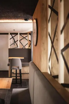 a dining room with a table and a chair at Hotel Fernblick in Bressanone