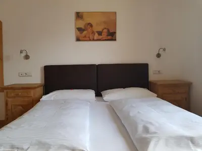 a bathroom with a wooden dresser and a mirror at Hotel Fernblick in Bressanone
