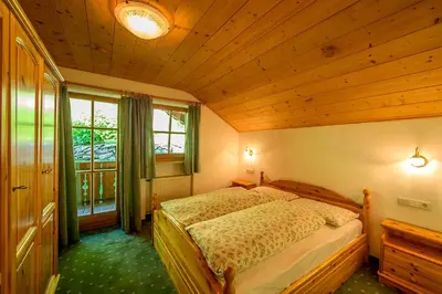 a bedroom with a bed with a wooden ceiling at Leithäusl in San Lorenzo di Sebato