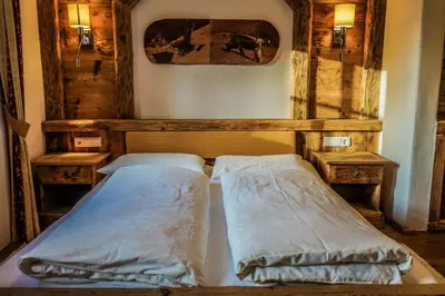 a bed in a room with two pillows at Leithäusl in San Lorenzo di Sebato
