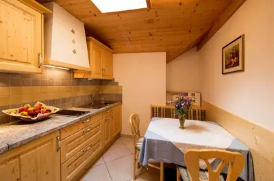 a kitchen with a table with a bowl of fruit on it at Leithäusl in San Lorenzo di Sebato
