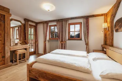 a bedroom with two beds and windows at Leithäusl in San Lorenzo di Sebato
