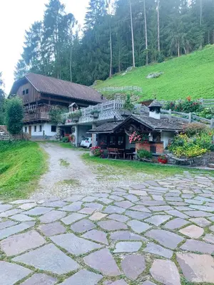a log cabin with a dog in the snow at Leithäusl in San Lorenzo di Sebato