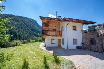 a house with a balcony on the side of it at Apartments Berdan in Santa Cristina in Val Gardena