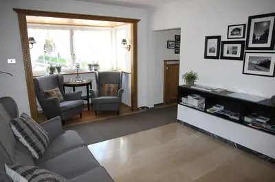 a living room with a couch and chairs and a table at Garni Hotel Max in Santa Cristina in Val Gardena