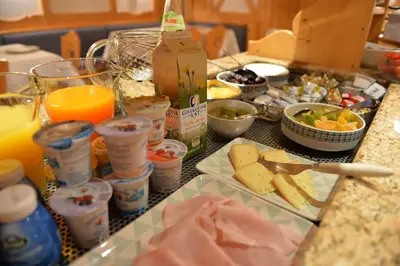 a table with a bunch of food on a counter at Garni Hotel Max in Santa Cristina in Val Gardena