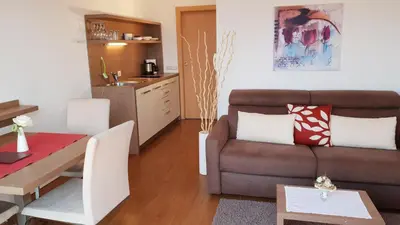 a living room with a couch and a table at Appartements Dornach in Schenna
