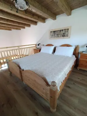 a bedroom with a large wooden bed with white pillows at I girasoli in Sanzeno