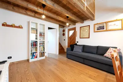 a living room with a couch and a book shelf at I girasoli in Sanzeno