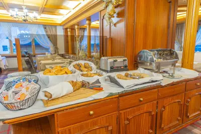 a table with a bunch of food on it at Hotel Meida in Pozza di Fassa