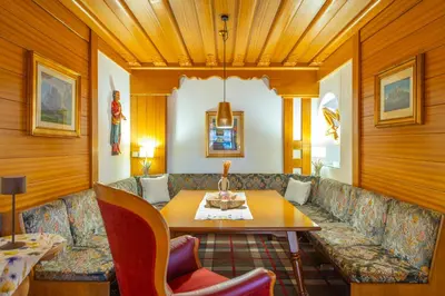 a living room with a couch and a table at Hotel Meida in Pozza di Fassa