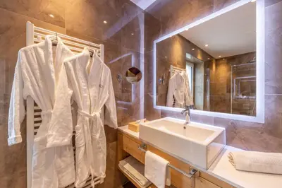 a bathroom with a sink and a mirror at Hotel Meida in Pozza di Fassa