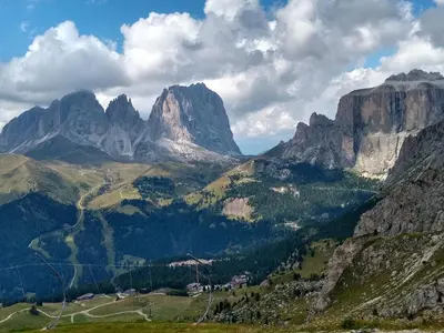 a view of a mountain valley with trees and mountains at Appartamento Campitello House in Campitello di Fassa
