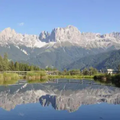 a view of a mountain range with a reflection in the water at Haus Helga in Tires