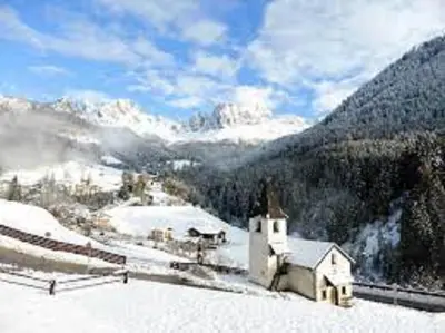 a small church in the snow on a mountain at Haus Helga in Tires