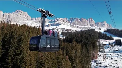 a group of people riding a ski lift in the mountains at Haus Helga in Tires