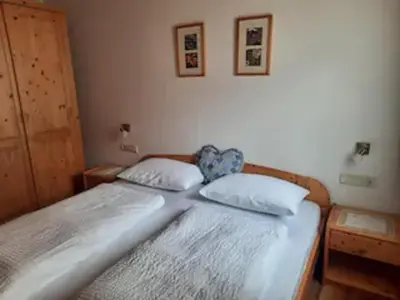 a bed with two pillows on it in a bedroom at Haus Helga in Tires