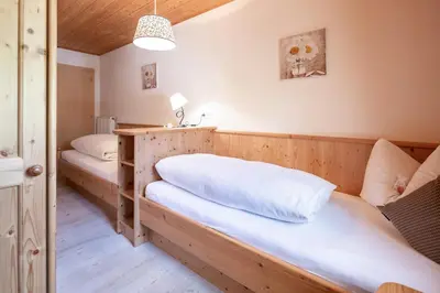 a bedroom with two beds in a room at Loefflerhof in Monguelfo