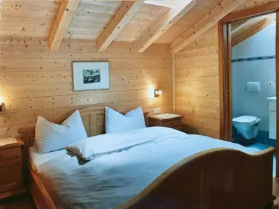 a bedroom with a bed in a wooden room at Ratzeshof in Castelrotto