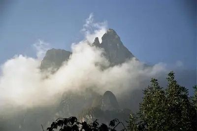 a mountain shrouded in clouds in the sky at Ratzeshof in Castelrotto