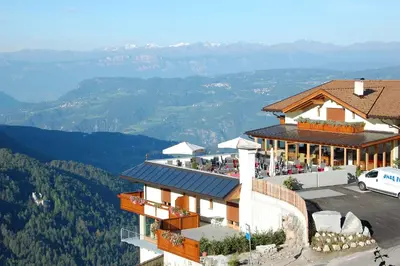 a large swimming pool in a hotel with chairs at Hotel Gstatsch in Alpe di Siusi