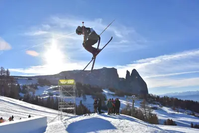 a view of a sunset with mountains in the background at Hotel Gstatsch in Alpe di Siusi