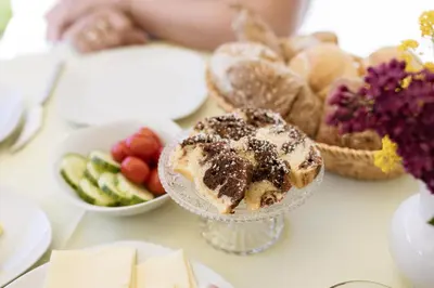 a table topped with a plate of food with a dessert at Pension Kleon in Rifiano