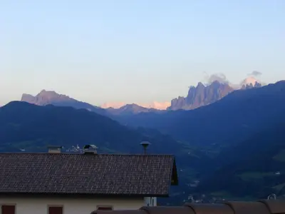 a view of mountains with a house in the foreground at Gasthaus St. Valentin in Chiusa