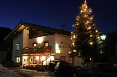 a christmas tree in front of a building at Gasthaus St. Valentin in Chiusa