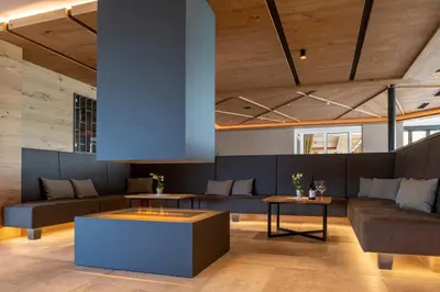 a living room with couches and tables at Hotel Sonnenheim in Avelengo