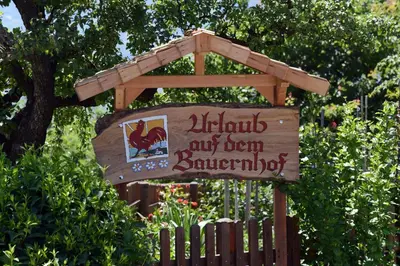 a sign in front of a fence with a sign at Plunerhof in Schenna