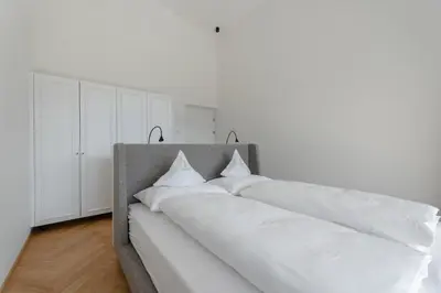two white pillows on a bed in a room at Schloss Plars wine & suites in Lagundo
