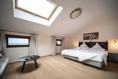 a large bedroom with a bed and a skylight at Schloss Plars wine & suites in Lagundo