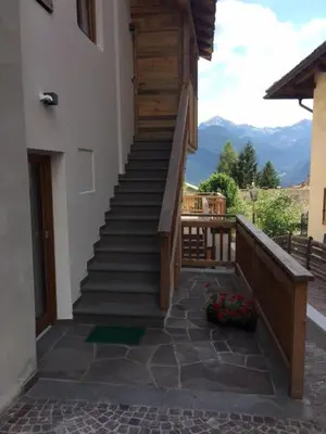 a stairway leading up to a building with a balcony at Casa Fabiolin in Daiano