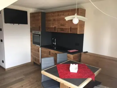 a kitchen with a table with a red cloth on it at Casa Fabiolin in Daiano