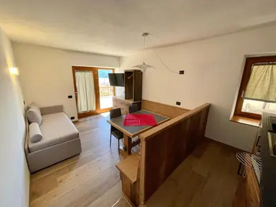 a living room with a couch and a table at Casa Fabiolin in Daiano