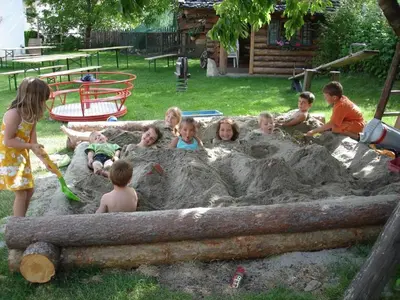 a group of children playing in a sand pit at Residence Klementhof 2 in Fiumes