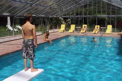 a man standing on a surfboard in a swimming pool at Residence Klementhof - A 208 3 in Fiumes