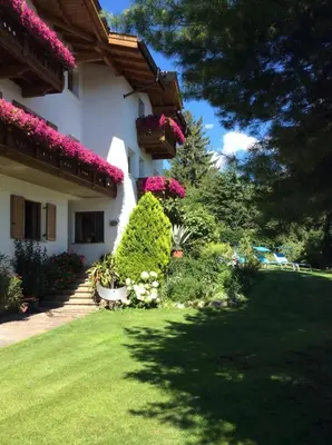 a house with flowers on the side of it at Residence Klementhof - A 208 3 in Fiumes