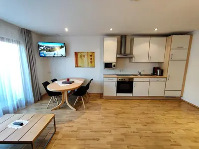 a kitchen and dining room with a table and a table at Residence Klementhof - A 208 3 in Fiumes