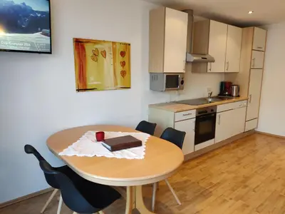 a kitchen and a table with a book on it at Residence Klementhof - A 208 3 in Fiumes
