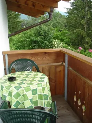 a patio with a table and chairs on a porch at Residence Klementhof 1 in Fiumes