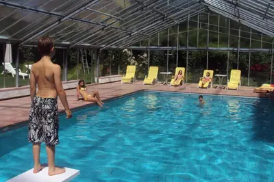 a man standing on a block in a swimming pool at Residence Klementhof 1 in Fiumes