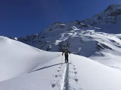 a person is skiing down a snow covered mountain at Falkensteiner Hotel & Spa Sonnenparadies in Terento