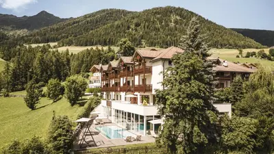 an image of a hotel in the mountains at Falkensteiner Hotel & Spa Sonnenparadies in Terento