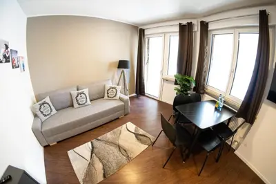 a living room with a couch and a table at Flow Apartments Karl Wolf Park in Merano