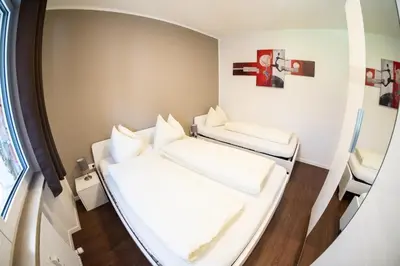 a small room with two beds and a mirror at Flow Apartments Karl Wolf Park in Merano