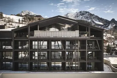 a rendering of a building with mountains in the background at AMA Stay in San Vigilio Di Marebbe
