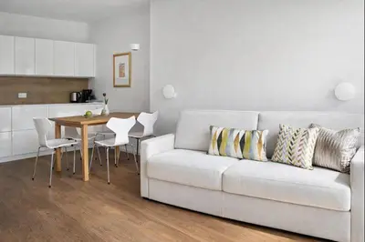 a living room with a white couch and a table at Hotel Gartenresidence Zea Curtis in Merano